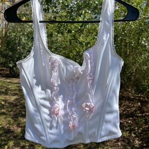 White and pink coquette corset top with bow detailing and wire ribbing